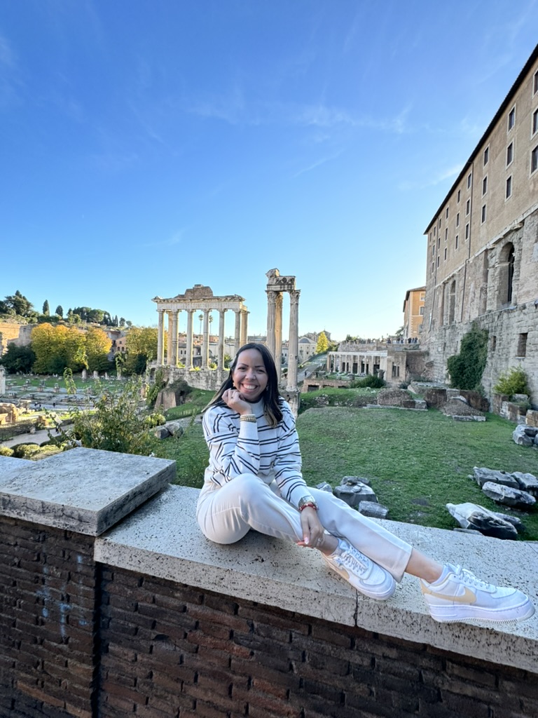 Anahely standing in front of the Colosseum in Rome